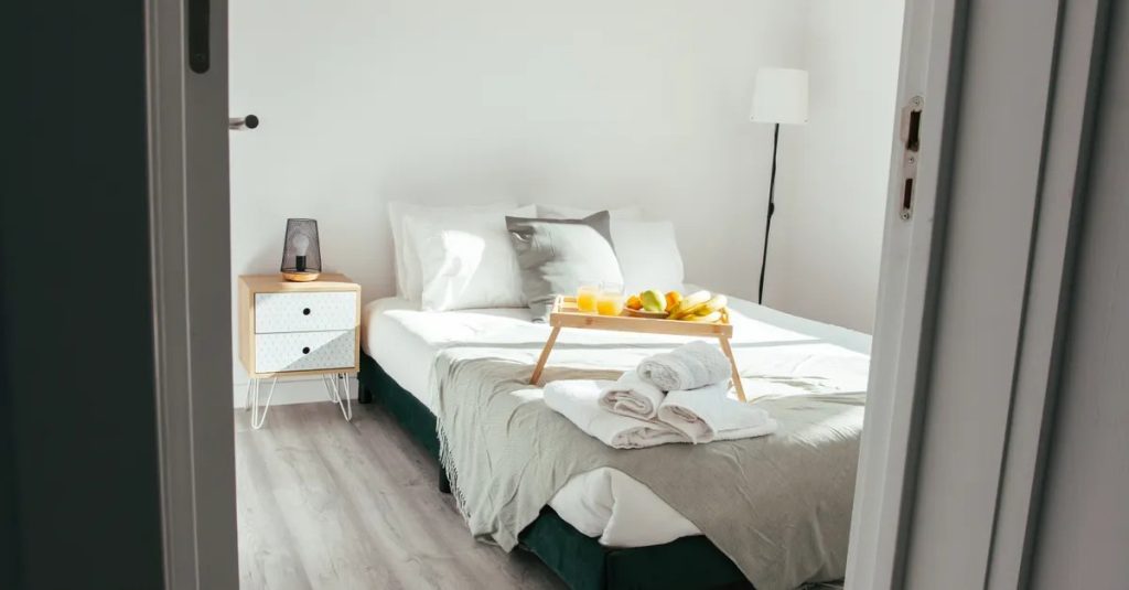 Bright vacation rental bedroom with a breakfast tray, ready for Airbnb guests