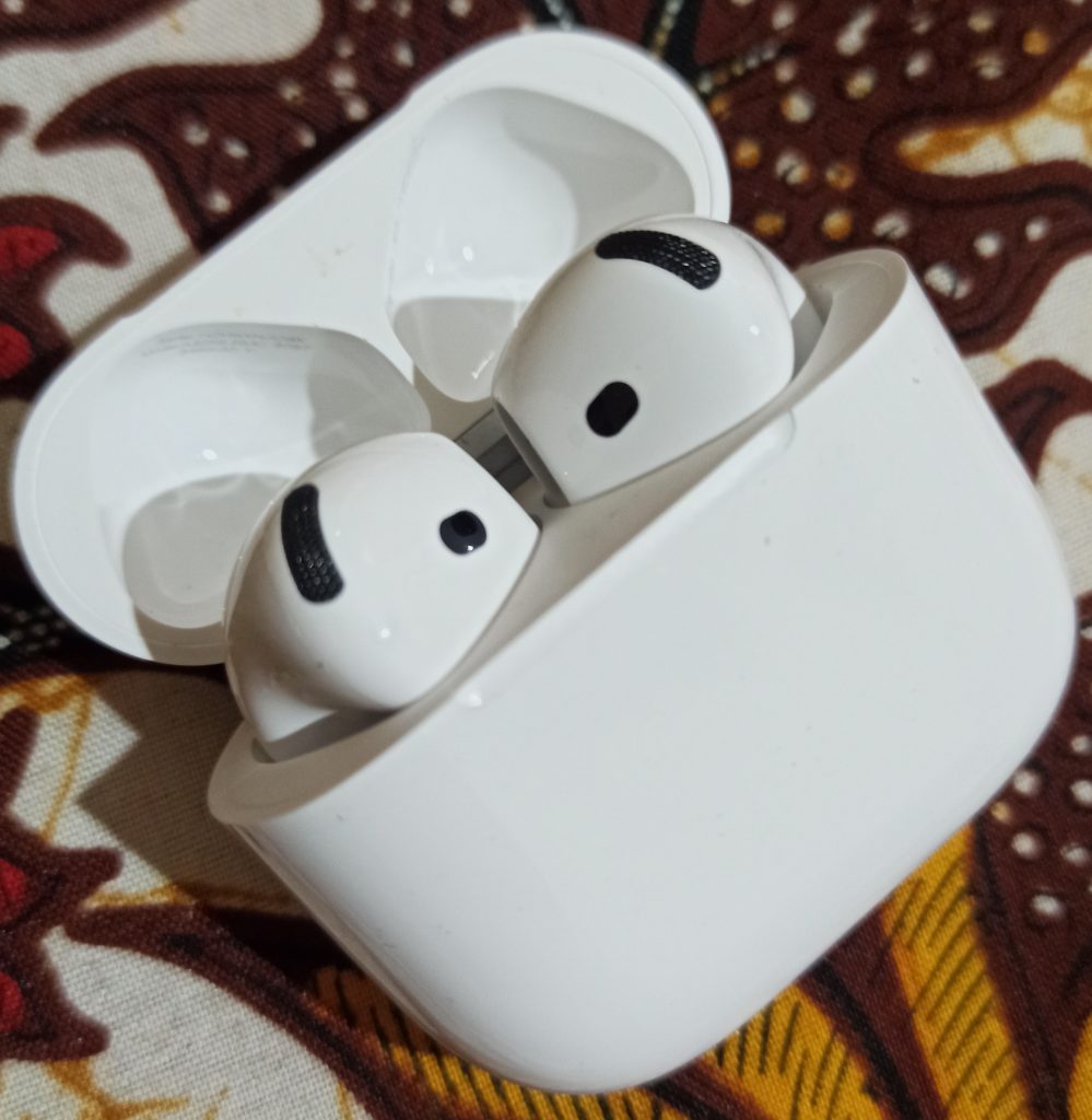 Apple AirPods 4 earbuds with wireless charging case