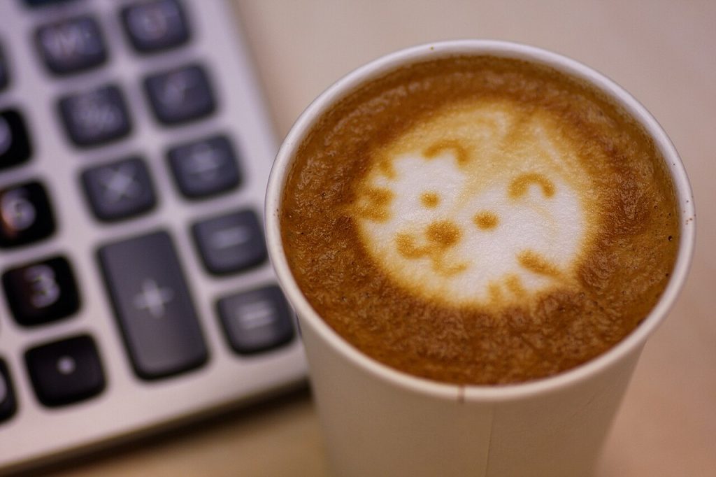Calculator on a bookkeeper's desk next to a coffee