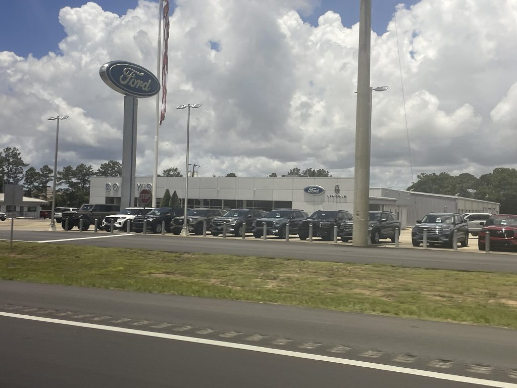 New vehicles lined up on a Ford dealership lot