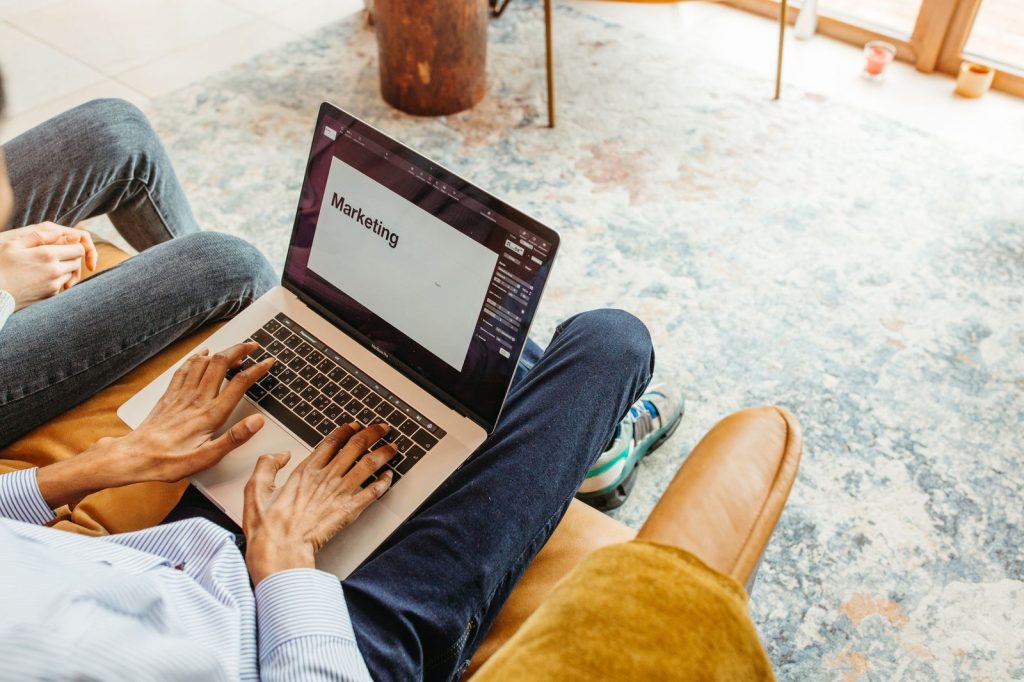 Marketer typing marketing copy on a laptop — Copy.ai vs Jasper comparison