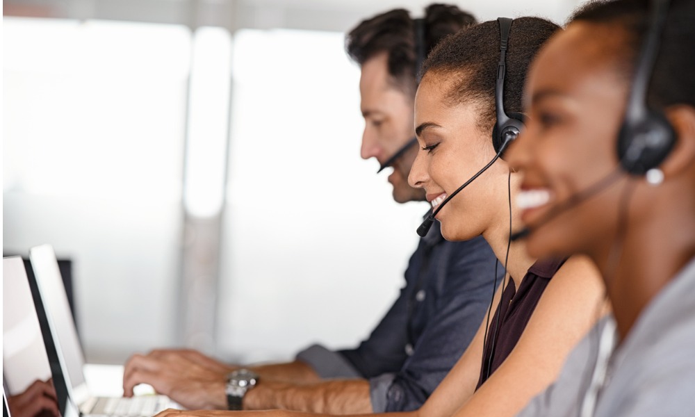 Customer support team wearing headsets at their workstations