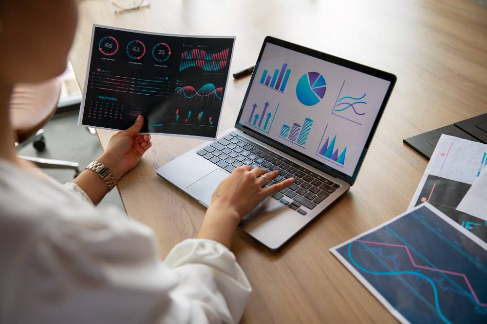 Data analyst working with charts on screens