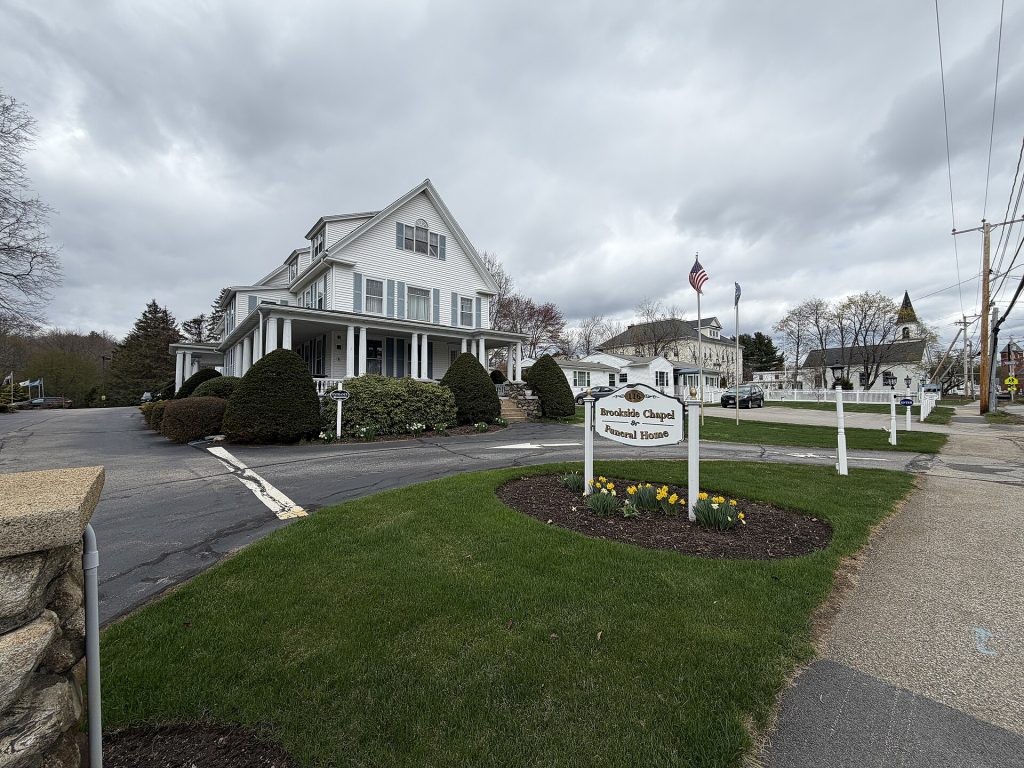 Brookside Chapel and Funeral Home, a white funeral home building with a sign and lawn