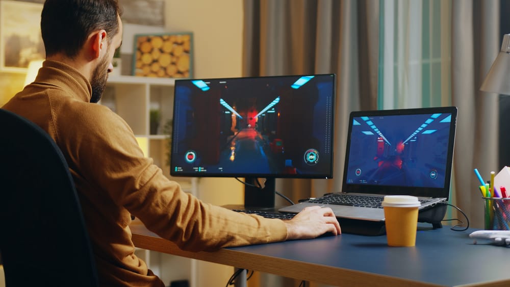 Game developer testing a game on two screens