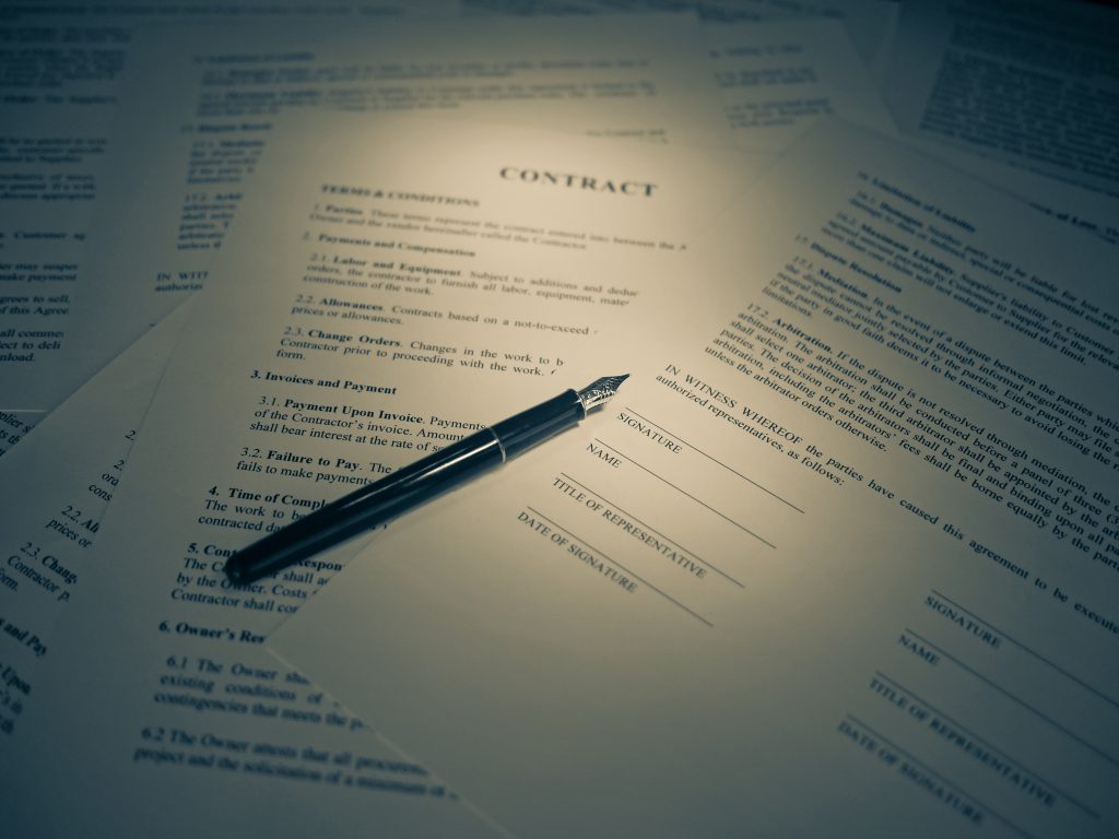 Fountain pen resting on a contract document