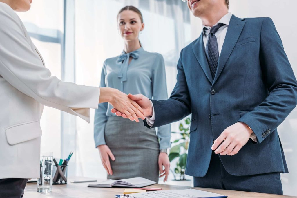 Job interview handshake in a bright office