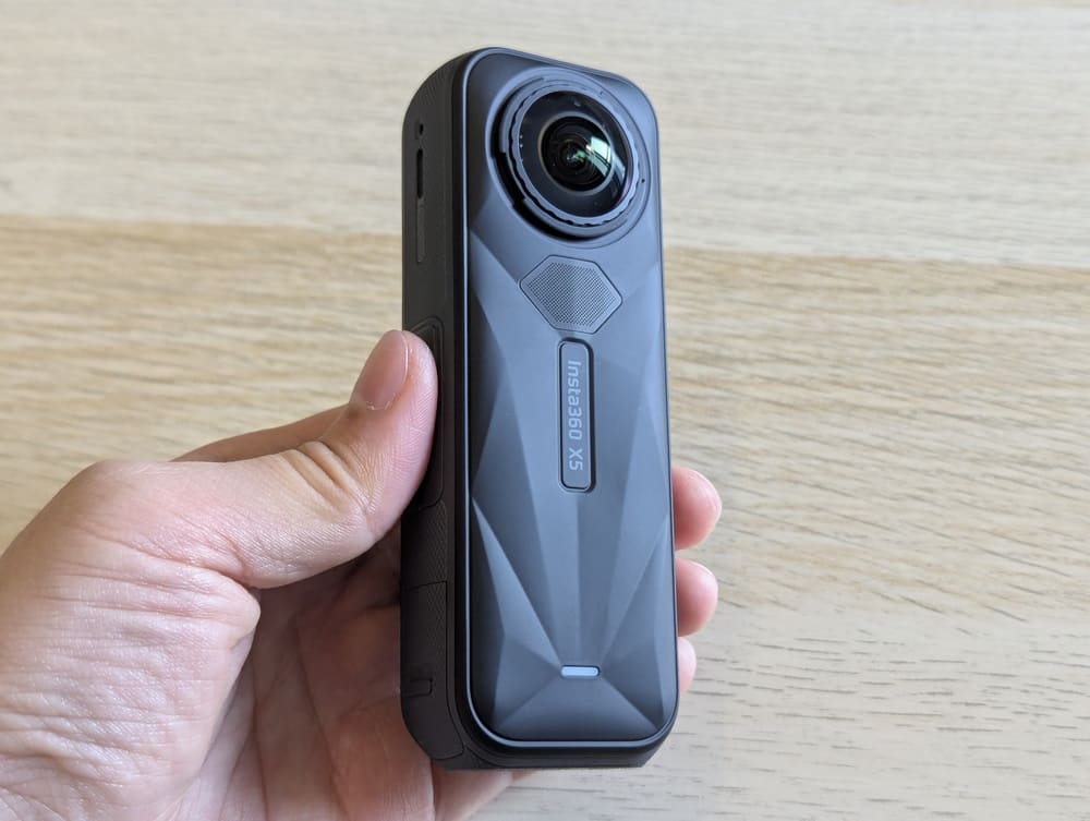 Insta360 X5 360 camera held in hand