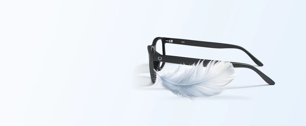 Lucyd Aero smart glasses frame resting on a feather