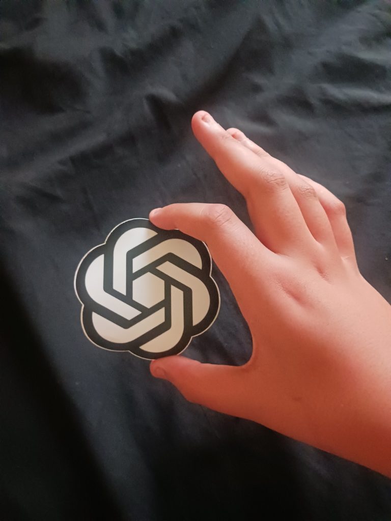 Person holding the OpenAI icon — the ChatGPT Meetings plugin is in beta for Pro and Business users on macOS