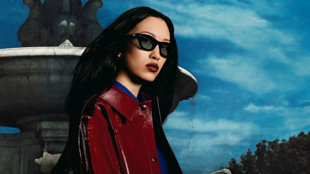 Model wearing black Ray-Ban Meta Gen 3 Zena cat-eye smart glasses outdoors