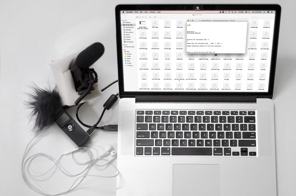 Content creator's desk with a laptop and a microphone
