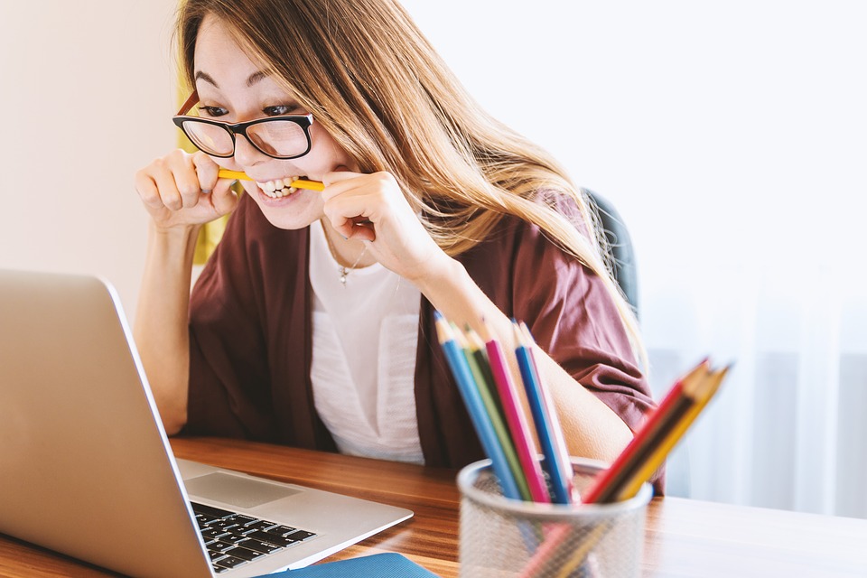 Student studying with a laptop and school supplies