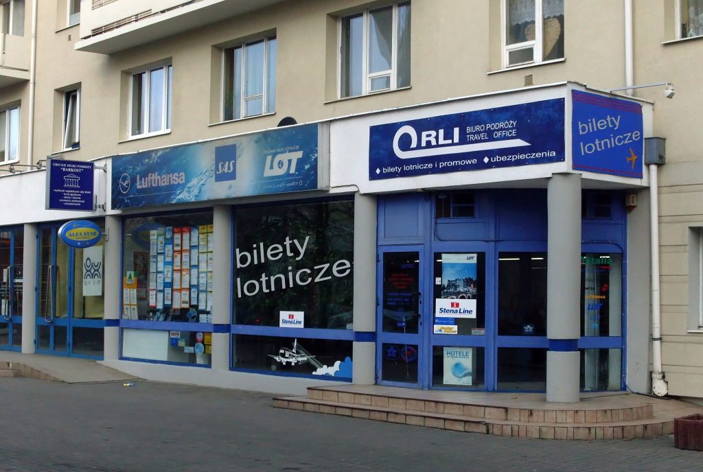A travel agency storefront offering flight tickets and travel services